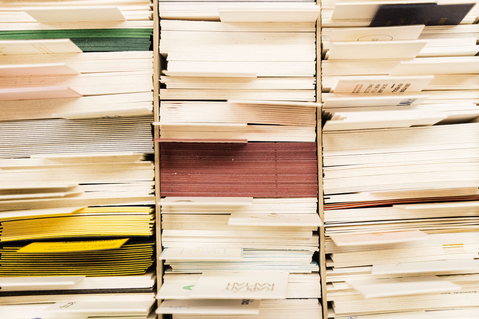 Tightly stacked page edges of many documents filling the frame