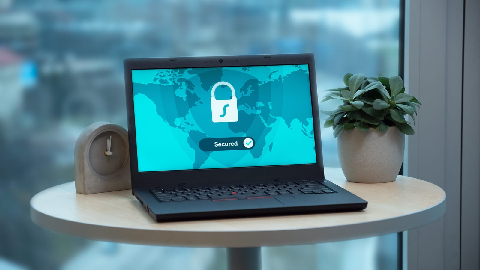 A laptop screen showing a padlock and secured-connection graphic
