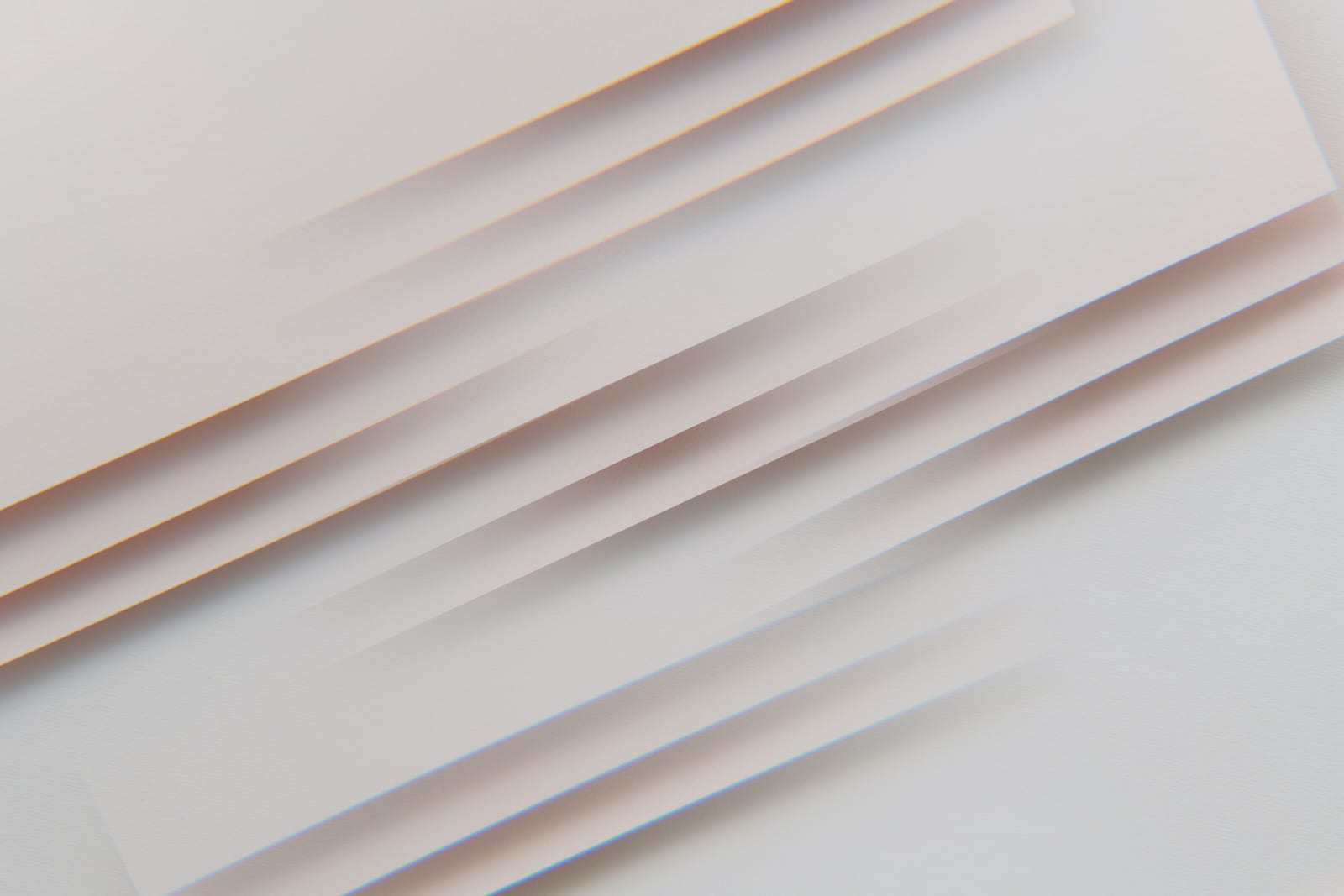 Layered white sheets of paper fanned at an angle